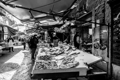 a market with a table full of food on it at Massimo Luxury Rooms in Palermo