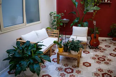 a room with a bench and plants and a guitar at Opera Suites - Norma in Palermo