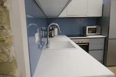 a kitchen with a sink and two faucets at Opera Suites - Norma in Palermo