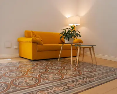 a living room with a yellow couch and a table at Opera Suites - Norma in Palermo
