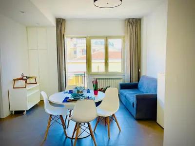 a living room with a table and chairs and a blue couch at 38 HOUSE in Palermo