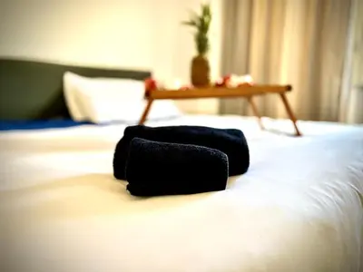 a black bag sitting on top of a bed at 38 HOUSE in Palermo