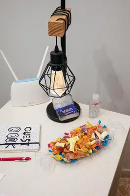 a table with a lamp and a plate of candy at Mille91 Apartment in Palermo
