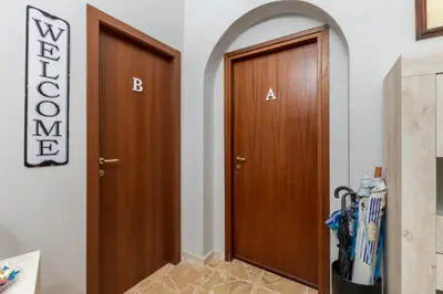 a pair of wooden doors in a hallway at Mille91 Apartment in Palermo