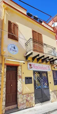 a yellow building with two doors and a balcony at Il Principe casa vacanze in Trabia