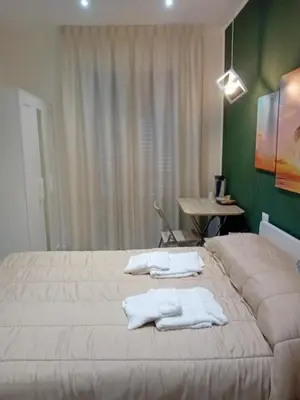 a bedroom with two white towels on a bed at ABT L'AURA in Palermo