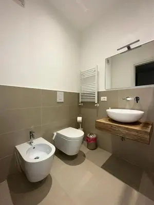 a bathroom with a sink and a toilet and a mirror at ABT L'AURA in Palermo
