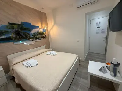 a bedroom with a bed with two towels on it at ABT L'AURA in Palermo