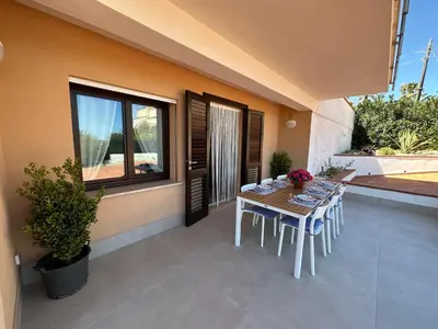 a table and chairs on the patio of a house at Villa FIORENZA in Castellammare del Golfo