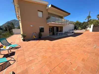 a brick patio in front of a house at Villa FIORENZA in Castellammare del Golfo