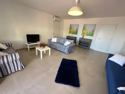 a living room with two couches and a tv at Villa FIORENZA in Castellammare del Golfo