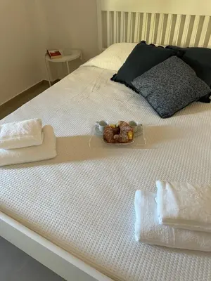 a bed with towels and a teddy bear on it at Villa FIORENZA in Castellammare del Golfo
