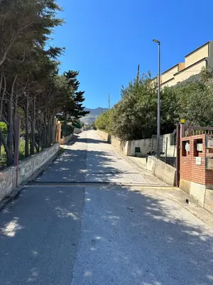 an empty street with trees on both sides of the road at Villa FIORENZA in Castellammare del Golfo