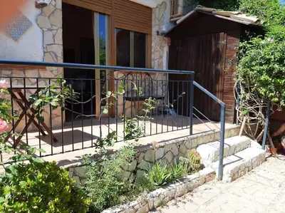 a metal railing on a set of stairs in front of a house at casa di Enrico in Palermo