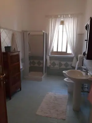 a bathroom with a sink and a toilet and a shower at casa di Enrico in Palermo