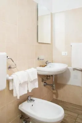 a bathroom with a sink and a toilet and a mirror at Meg Sicily House in Castellammare del Golfo