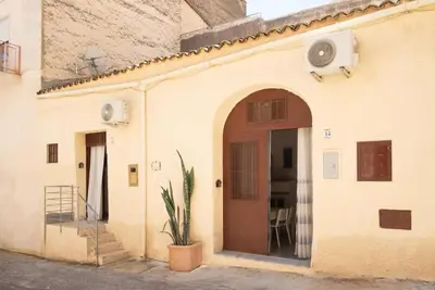 an entry to a building with a door and a plant at Meg Sicily House in Castellammare del Golfo