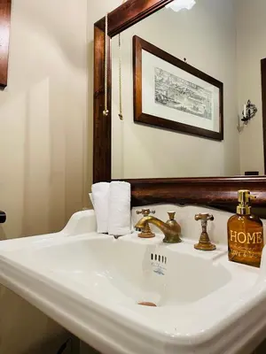 a bathroom with a white sink and a mirror at Villa Inserra Deluxe in Palermo
