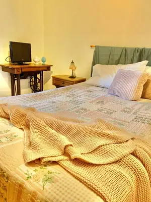 a bedroom with a bed with a blanket on it at Daziarosetta in Palermo