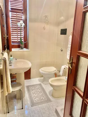 a bathroom with a toilet and a sink at Daziarosetta in Palermo
