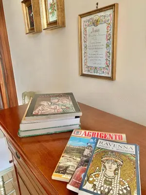 two books sitting on top of a wooden table at Daziarosetta in Palermo