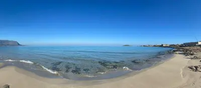 a view of the beach on a sunny day at VILLA DELLE POMELIE in Isola delle Femmine