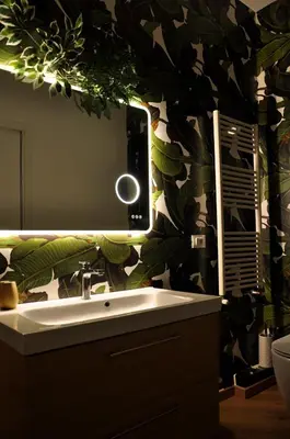 a bathroom with a sink and a large leaf wallpaper at Flat with Jacuzzi - Casa Pia in Mondello