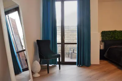 a living room with a black chair and a window at Flat with Jacuzzi - Casa Pia in Mondello