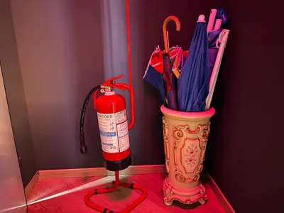 a fire extinguisher next to a container of umbrellas at Flat with Jacuzzi - Casa Pia in Mondello