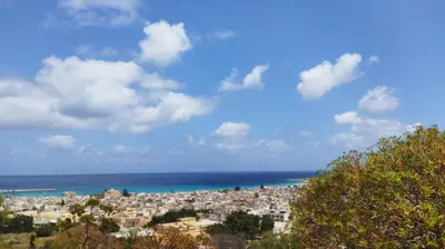a view of a city and the ocean at APPARTAMENTO A SAN VITO LO CAPO STANZA CON BAGNO in San Vito lo Capo