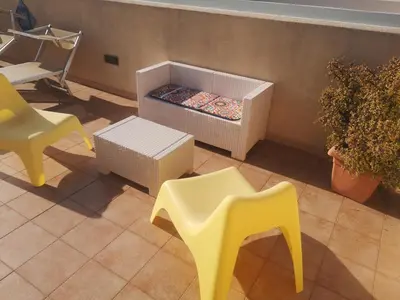 a room with two yellow chairs and a table at APPARTAMENTO A SAN VITO LO CAPO STANZA CON BAGNO in San Vito lo Capo