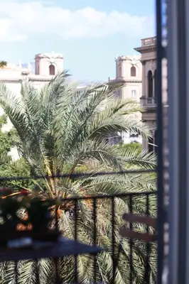 a group of palm trees in front of a building at Case Orlando_a city center Sicilian treat in Palermo