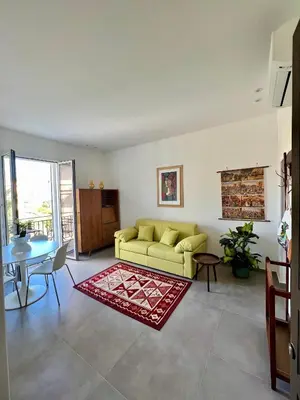 a living room with a yellow couch and a table at Case Orlando_a city center Sicilian treat in Palermo