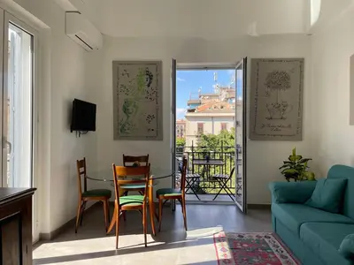 a living room with a table and chairs and a couch at Case Orlando_a city center Sicilian treat in Palermo