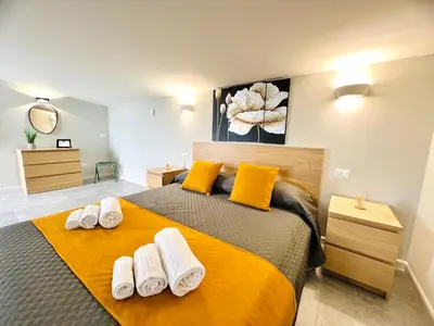 a bedroom with a large bed with towels on it at Piante del Principe Apartments in Carini