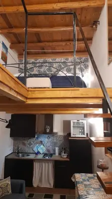 a bedroom with a bunk bed and a desk in a room at Casa vacanza Gio in Palermo