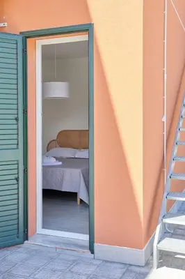 a sliding glass door leading to a bedroom at Salinelle Rooms in Lascari
