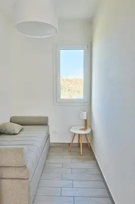a living room with a couch and a window at Salinelle Rooms in Lascari
