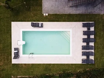 an overhead view of a swimming pool with chairs at Salinelle Rooms in Lascari