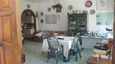 a kitchen with a table and chairs in a room at Villa Mare Ercole Luxury in Trappeto