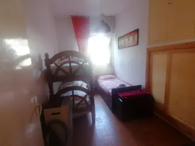 a room with a bed and a chair and a window at Villa Mare Ercole Luxury in Trappeto