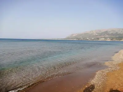 a beach with the ocean and mountains in the background at Villa Mare Ercole Luxury in Trappeto
