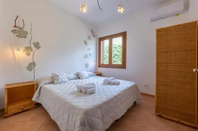 a bedroom with a bed with two towels on it at Pittalumari Makari in Macari