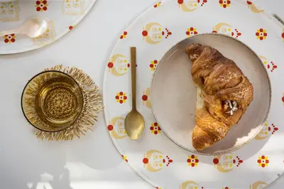 a plate of food with a croissant on a table at Pittalumari Makari in Macari