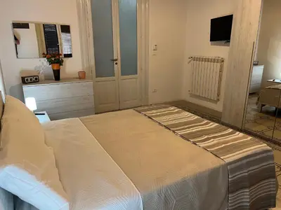 a bedroom with a large bed in a room at SPYDA in Palermo