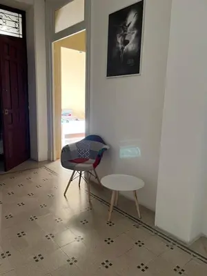 a chair and a table in a room at SPYDA in Palermo