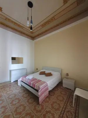 a bedroom with a bed and a table in it at SPYDA in Palermo