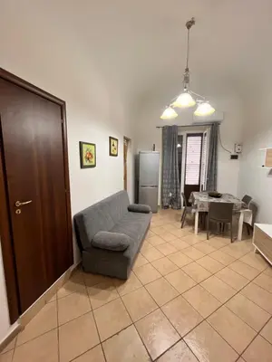 a living room with a couch and a table at House del Corso Calatafimi in Palermo