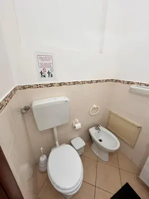 a small bathroom with a toilet and a sink at House del Corso Calatafimi in Palermo