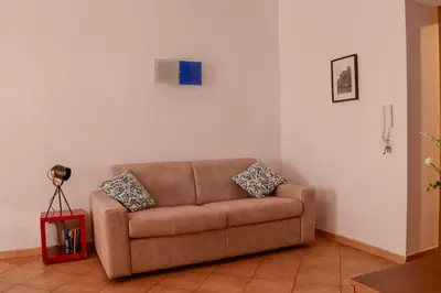 a brown couch sitting in a living room at Happie Casa Il Capo & La Cattedrale in Palermo